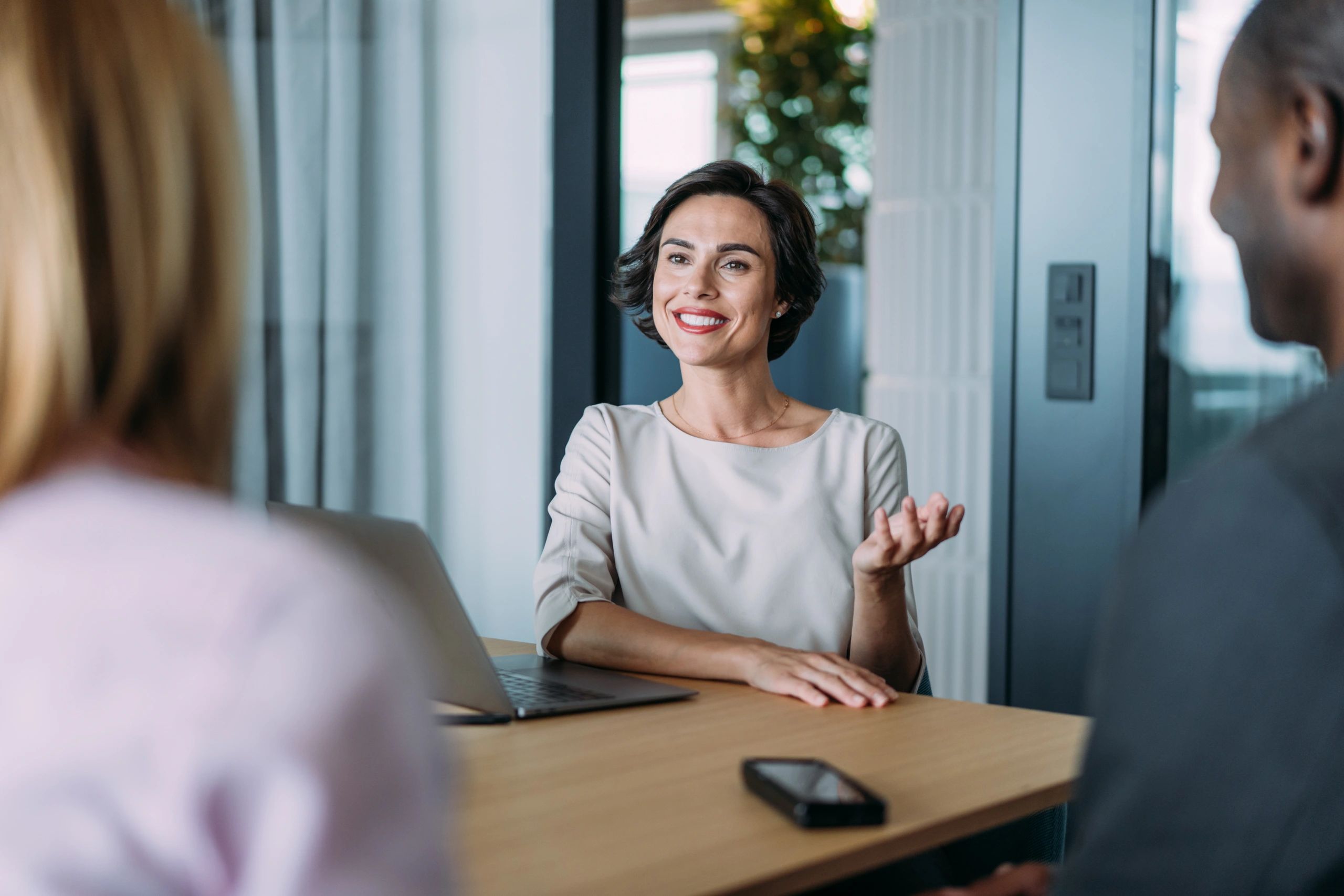 Professional financial advisor consulting with client in modern office